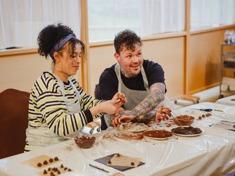 Couples making truffles together at a chocolate-making class